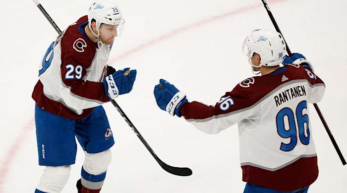 Colorado Avalanche's Nathan MacKinnon (29) is congratulated by Mikko Rantanen after scoring against the Boston Bruins during the second period of an NHL hockey game Monday, Feb. 21, 2022, in Boston.
